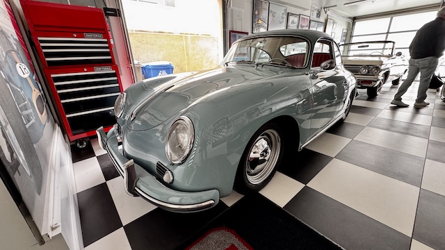 blue Porsche sports car in garage