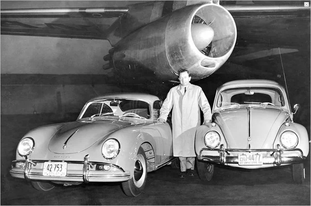 Man with two old cars