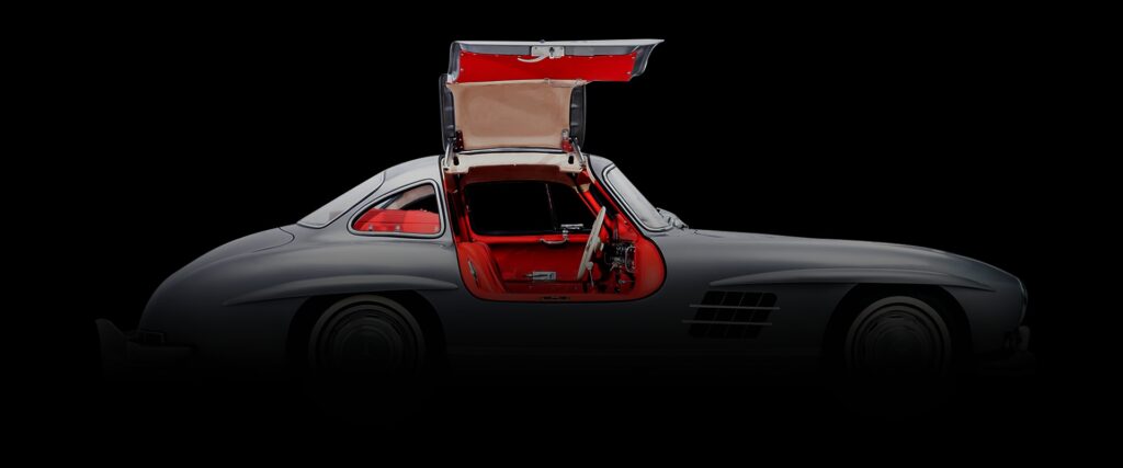 Silver and red Mercedes Benz Gullwing car